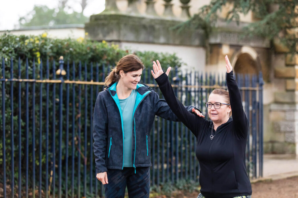 Personal training session outdoors with a mum to boost wellbeing and reduce stress levels.